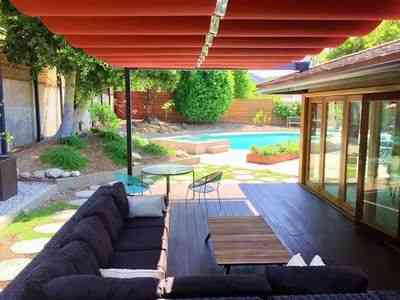 Red fabric awnings over poolside patio